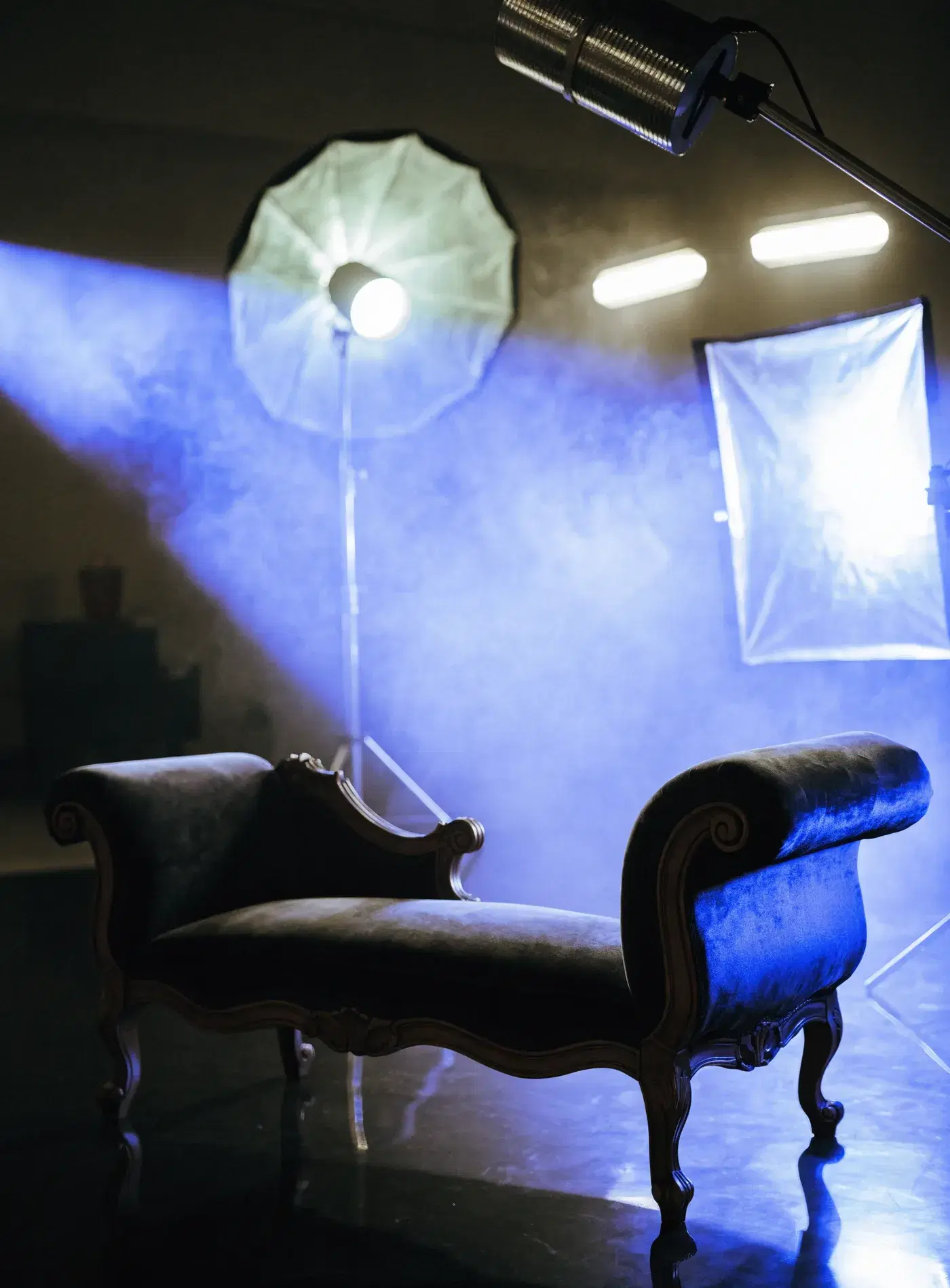 Professional content creation studio in Wellington with elegant chaise and electric blue lighting